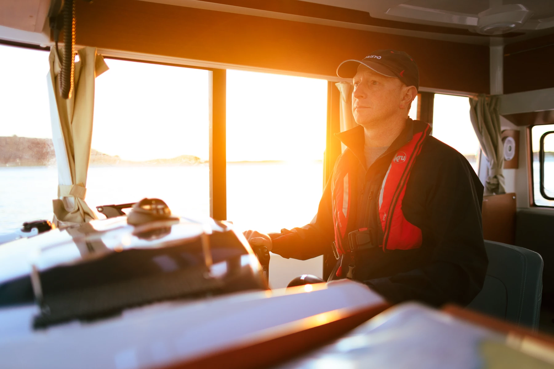 Colour photo of a person sitting in a vehicle