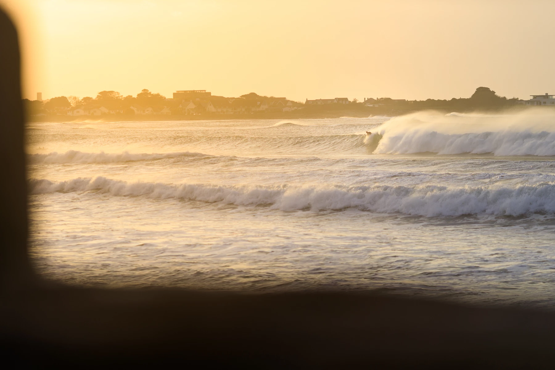 Colour photo of waves crashing on a beach
