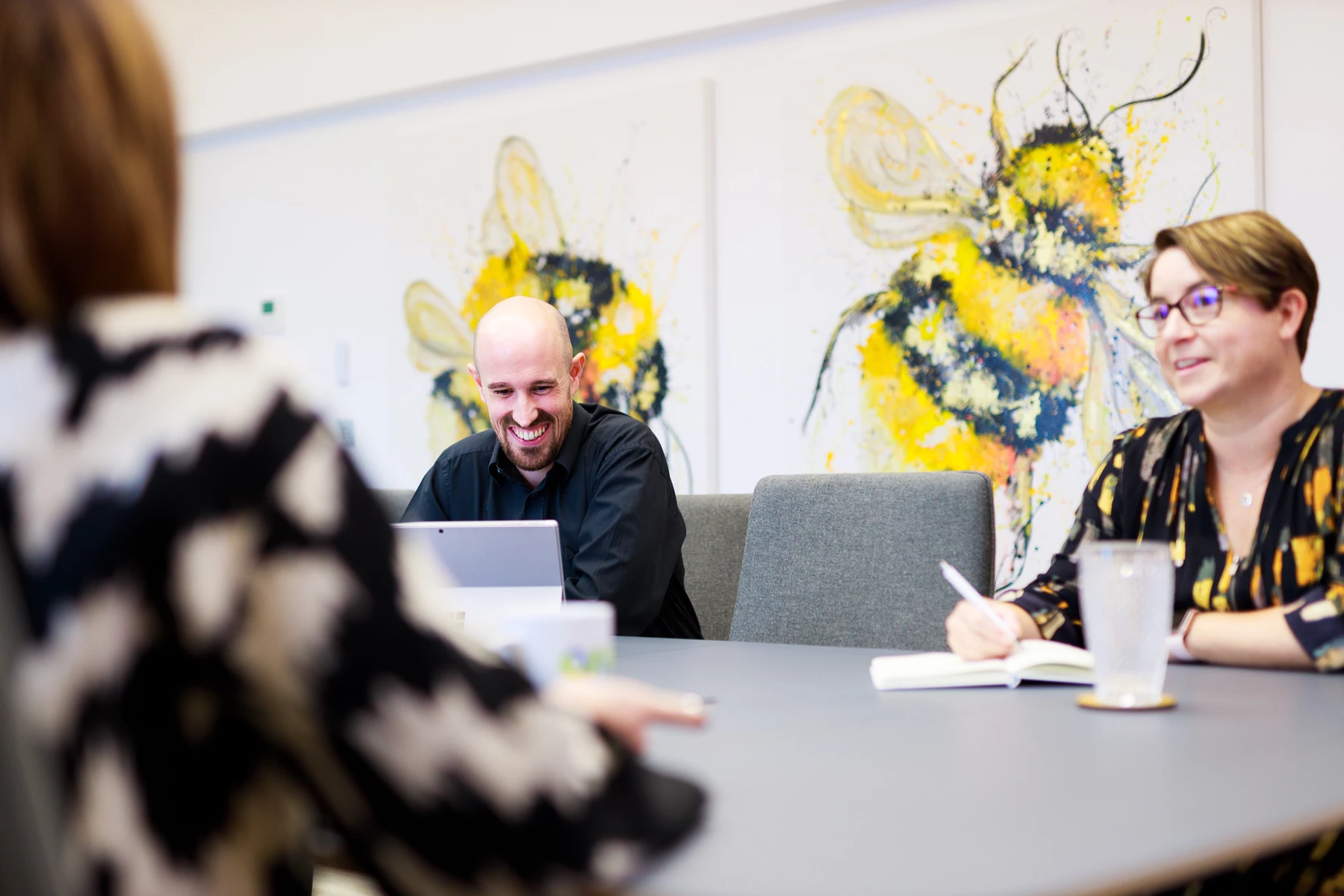 Colour photo of a group of people sitting around a table