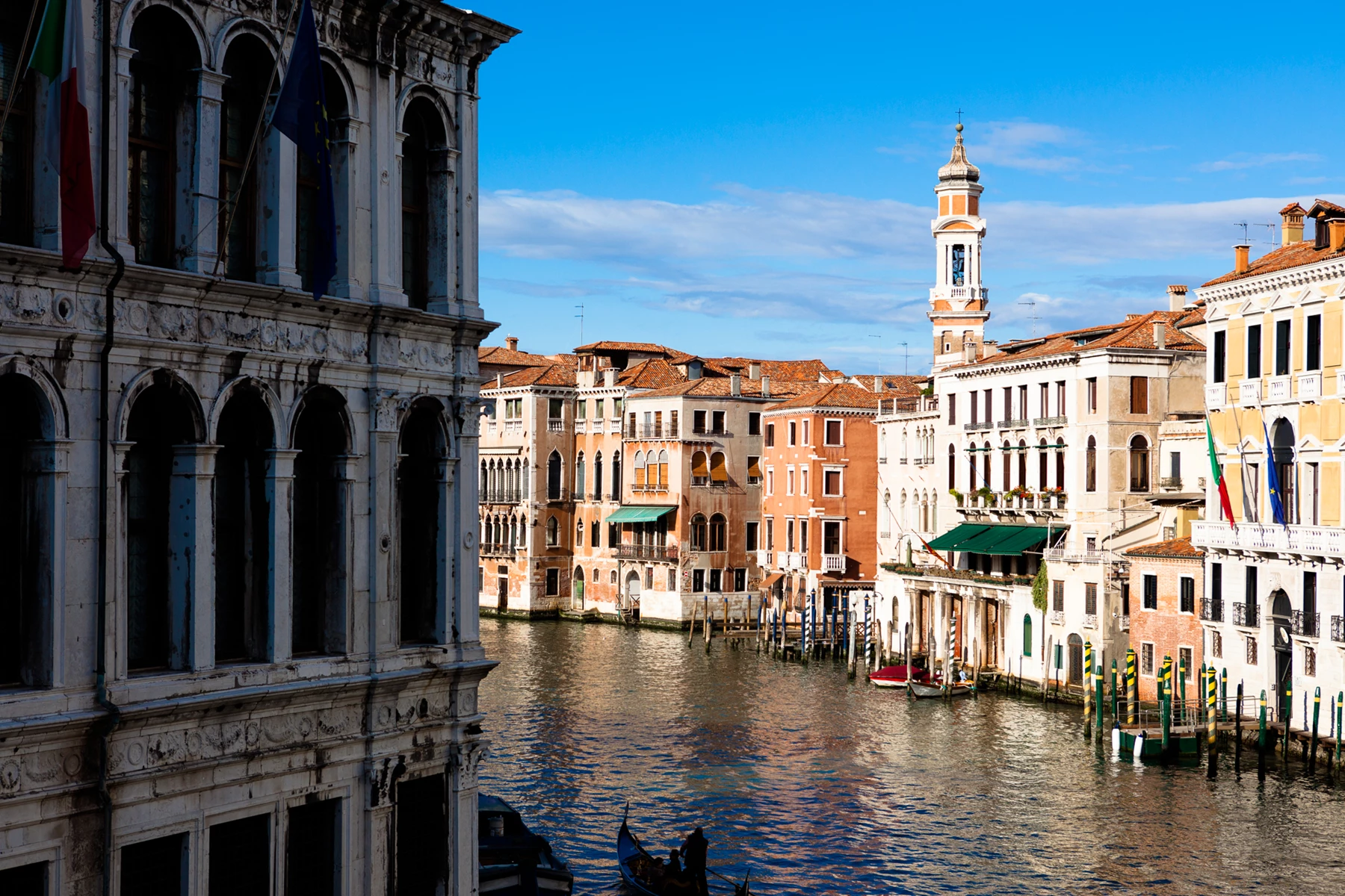 Colour photo of a canal with buildings along it
