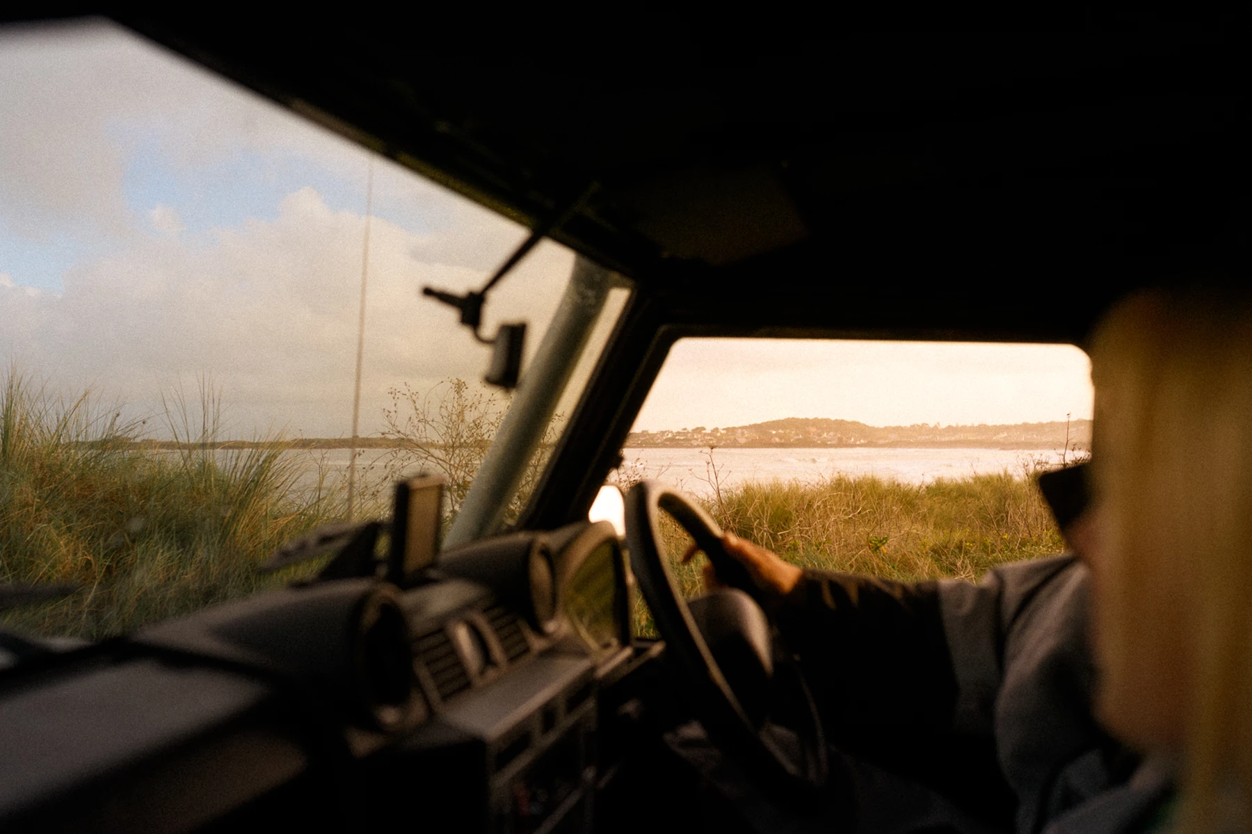 Colour photo of a person driving a car