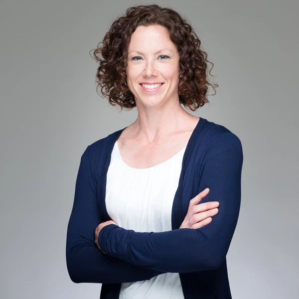 Business portrait of woman against grey background