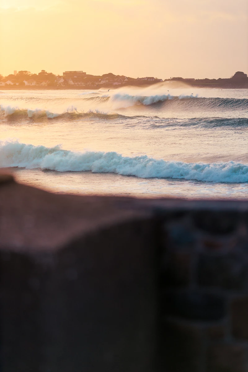 Colour photo of waves crashing on a beach